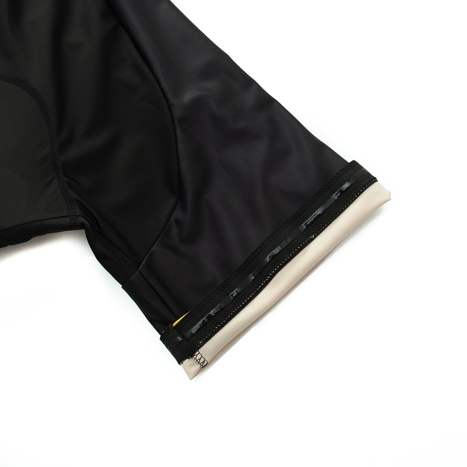 A close-up of the Dont Stop Riding Cycling Jersey Set highlights a black sleeve with a beige cuff, crafted from lightweight polyester. Featuring a zipper and smooth shiny texture, it offers sporty comfort and breathability. The background is plain white.