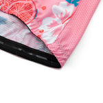 Close-up of the Womens Pink Floral Cycling Jersey Set featuring a citrus and floral print. The lightweight, mesh fabric blends pink, white, and blue hues with a black elastic band edge for stylish functionality on rides.