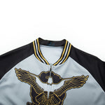 Close-up of the US Army Veteran Cycling Jersey Set, highlighted by an embroidered eagle with gold and black wings. The striped collar and sleeves give a jersey-like style, while the mainly gray body offers classic elegance.