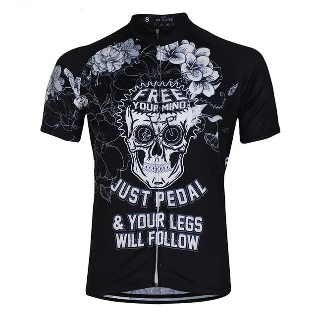 Introducing the Just Pedal Skull Cycling Jersey: a black polyester performance piece with a bold white skull and floral design. Free Your Mind tops the graphic, followed by Just Pedal & Your Legs Will Follow. It features a full-length zipper for ultimate convenience.