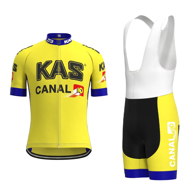 The KAS Canal Retro Cycling Jersey Set features a yellow jersey with KAS and CANAL 10 logos, blue and white accents, and short sleeves. The matching bib shorts come in black, yellow, and white with the CANAL 10 logo for a vintage style.