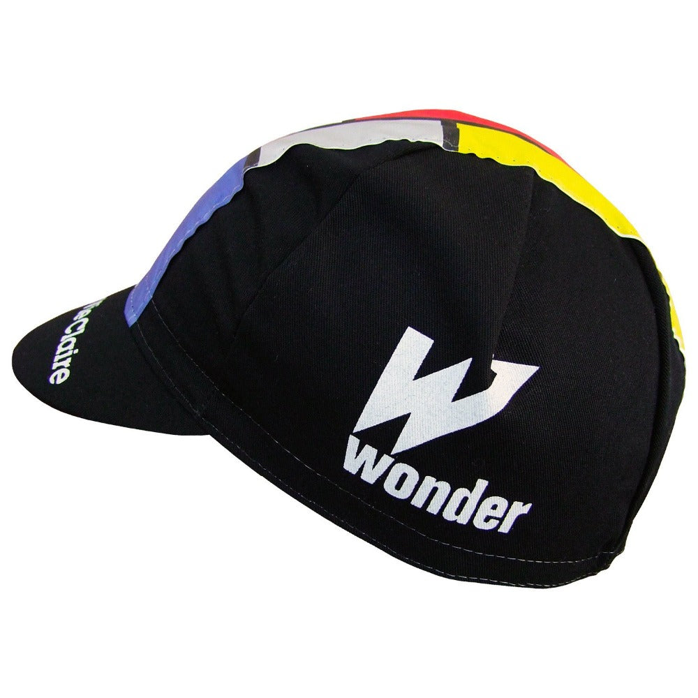 The La Vie Claire Retro Cycling Cap showcases a geometric design in black, blue, red, and yellow. With its vintage charm, it features a black brim and the word wonder with a prominent W on the side, capturing the essence of retro cycling style.