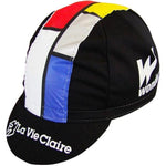 The La Vie Claire Retro Cycling Cap showcases black, red, yellow, blue, and white geometric patterns inspired by Mondrians art. The white text La Vie Claire adds a touch of vintage cycling fashion to the design.