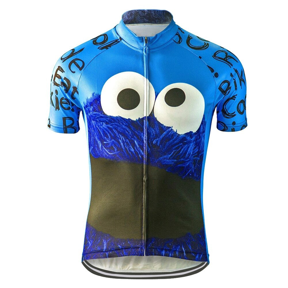 The Cookie Monster Ride Eat Retro Cycling Jersey features a blue design with a cartoon character, large eyes, and furry face. Styled with cookie-themed text on the sleeves and sides, this jersey includes a full-length zipper, making it ideal for Sesame Street fans who love cycling.