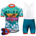 Join the Miami Cycling Team with a retro cycling jersey set featuring a tropical theme. The teal and red jersey and bib shorts are adorned with palm trees and florals, offering padded seat inserts for comfort while riding in style.
