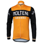 The Molteni Arcore Retro Cycling Jersey features long sleeves, an orange design with black accents on the center and sleeves, MOLTENI in white across the chest and sleeves, ARCORE beneath it, a central zipper for ease, and pays homage to Eddy Merckxs era. Fleece option available.