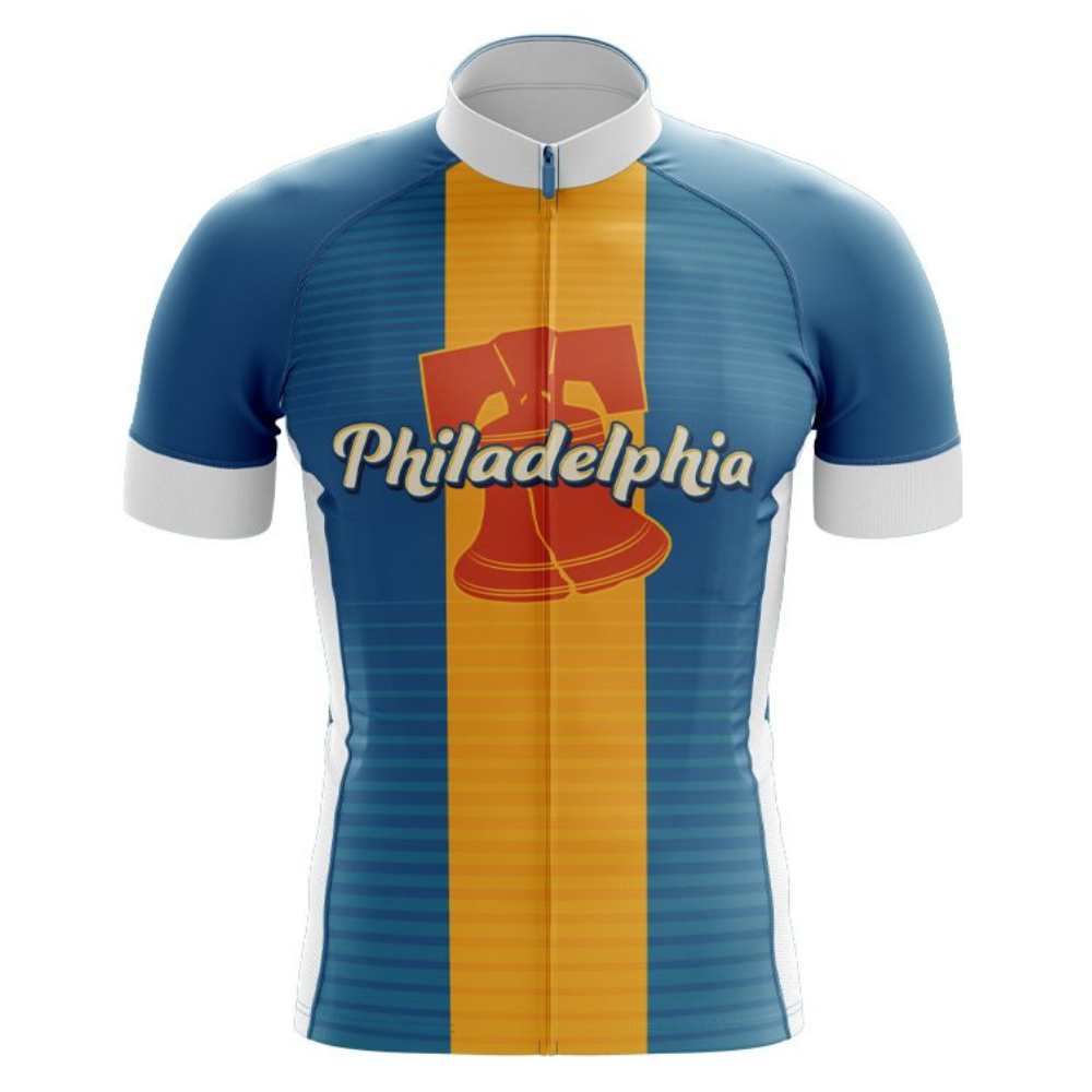 The Philadelphia USA Retro Cycling Jersey showcases blue and orange vertical stripes, a stylized Liberty Bell, and Philadelphia in cursive across the chest. It features a white collar and sleeve cuffs, capturing a classic retro design.