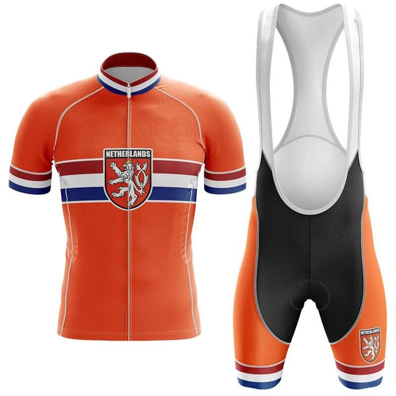 The Netherlands Pro Team Cycling Jersey Sets feature a short-sleeve, orange jersey with Netherlands text, a lion crest on the chest, and white/blue stripes. The black bib shorts include orange sections, the same crest, and a gel seat pad for added comfort.