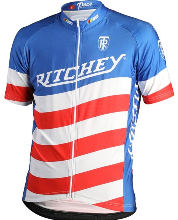 The Ritchey Team Retro Cycling Jersey is a performance-focused, short-sleeve top made of lightweight polyester. It features a front zipper, blue shoulders with bold diagonal red and white stripes, and RITCHEY with logos on the chest.