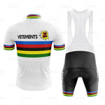 The Tomasso Team Z Vetements Retro Cycling Jersey Set is a must-have for enthusiasts, featuring a predominantly white jersey with colorful stripes, VETEMENTS text, a cartoon explosion graphic, and a nod to Team Z. The black bib shorts complement the jersey with matching multicolor stripes.