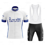 The Frigos Boston Retro Cycling Jersey Set includes a breathable, short-sleeved jersey in white with blue accents and Boston Frigos text, paired with black bib shorts featuring the same text. The jersey design offers a convenient full front zipper.