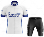 The Frigos Boston Retro Cycling Jersey Set includes a breathable white and blue jersey with Frigos Boston text, featuring short sleeves and a zippered front, paired with black shorts that provide comfort through a padded seat area.