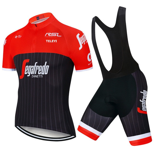 The Segafredo Zanetti Cycling Jersey Set includes a red and black jersey with short sleeves, a zippered front, bold white text, and logos. The black bib shorts feature red and white accents that complement the jerseys design and branding.
