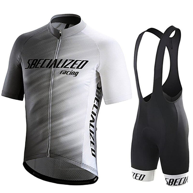 The Specialized Racing Team Cycling Jersey Set includes a black-and-white short-sleeve jersey with a front zipper and text, paired with black bib shorts featuring white leg bands. This breathable gear guarantees maximum comfort on every ride.