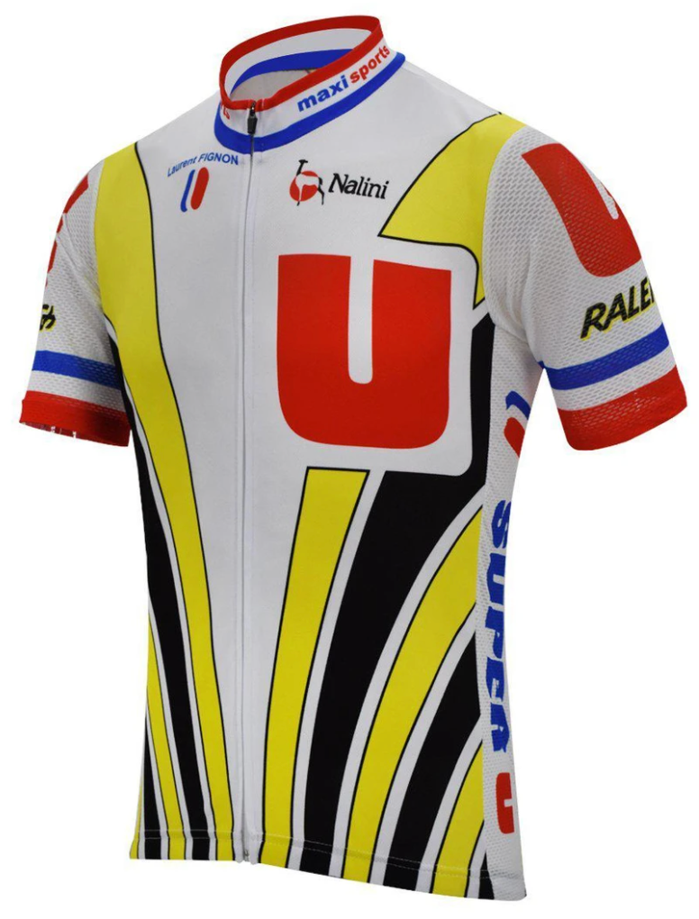 The Super U Raleigh Retro Cycling Jersey is inspired by the 1989 Tour de France, featuring large red and white U logos, yellow and black curved stripes, and blue, white, and red accents. Raleigh and Nalini branding enhance its classic appeal—ideal for fans!.