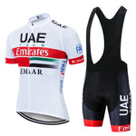 The UAE Emirates Cycling Team Jersey Set includes a white, lightweight polyester short-sleeve jersey with UAE Team Emirates branding in red, green, and black, a silicone waist strip, and matching black bib shorts with red accents and sponsors logos.