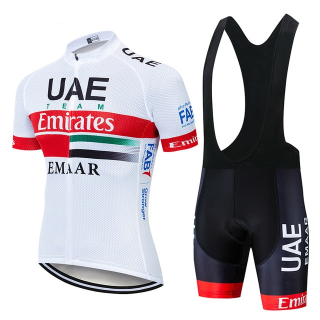 The UAE Emirates Cycling Team Jersey Set includes a white, lightweight polyester short-sleeve jersey with UAE Team Emirates branding in red, green, and black, a silicone waist strip, and matching black bib shorts with red accents and sponsors logos.