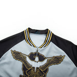 Close-up of the US Army Veteran Cycling Jersey Set, highlighted by an embroidered eagle with gold and black wings. The striped collar and sleeves give a jersey-like style, while the mainly gray body offers classic elegance.