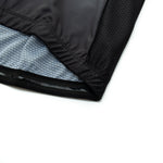 Close-up of a black fabric from the US Army Veteran Cycling Jersey Set, showing the edge and inner gray lining with a grid pattern. The athletic wear material displays texture and stitching details on a white background.