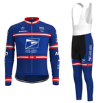 The US Postal Service Pro Cycling Team Jersey Long Set is a blue kit inspired by the team, featuring a long-sleeve zippered jersey with red and white stripes and logos, paired with bib shorts having matching blue and white accents.