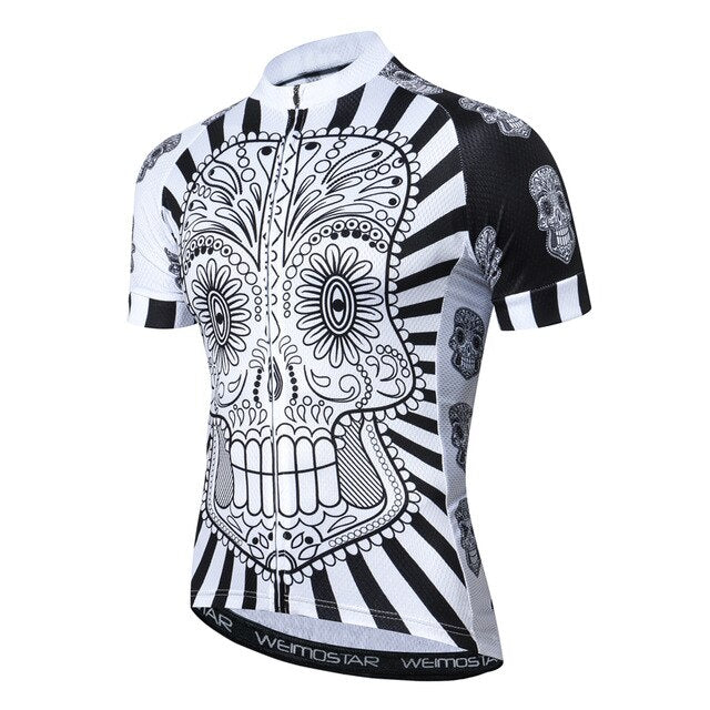 Introducing the White Skull with Black-White Patterned Body Cycling Jersey, showcasing a black and white sugar skull design, floral and geometric patterns on a radial striped background, and matching motifs on the sleeves. Made from lightweight polyester for breathable performance.