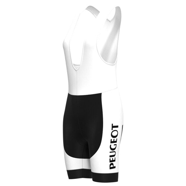 The Womens 1960s Peugeot-Shell Retro Cycling Jersey Set features white and black bib shorts with PEUGEOT printed vertically, reminiscent of vintage jerseys. It has a racerback design transitioning smoothly from the white top to black shorts, set against a white background.