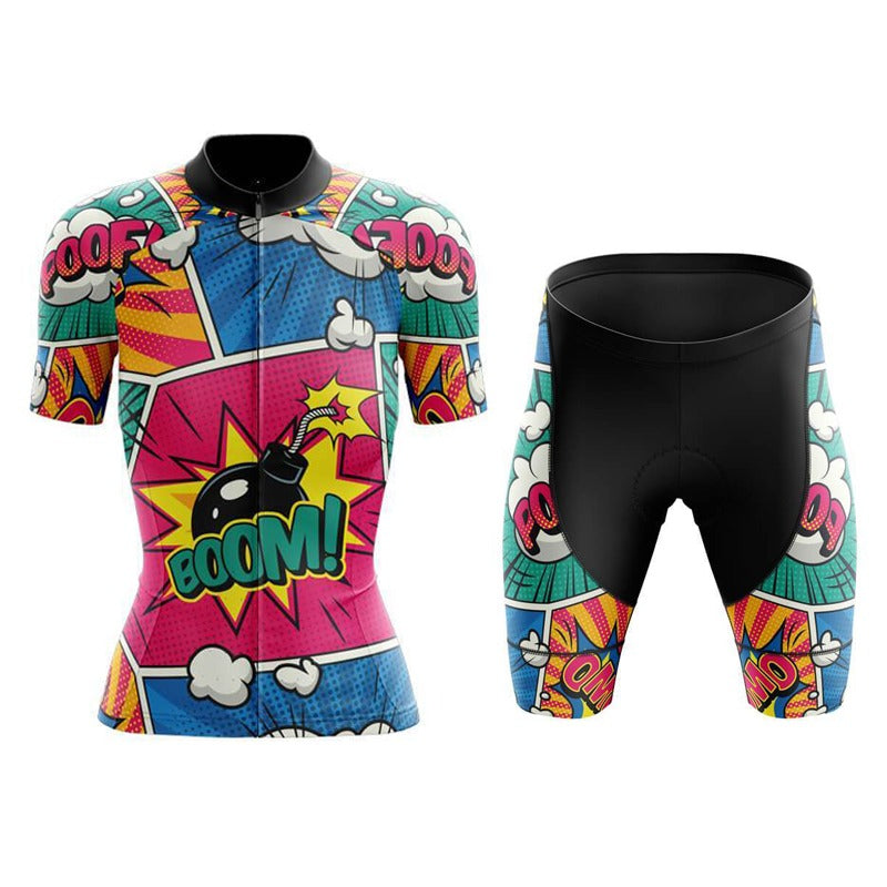 The Womens Explosive Comic Book Pink-Green Cycling Jersey Set features a vibrant comic-themed design with colorful panels, speech bubbles, and a central BOOM! graphic in pink, blue, yellow, and white. It includes a gel seat pad for added comfort.