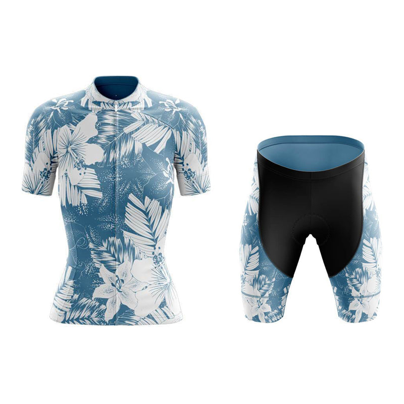 The Womens Floral Blue Lily Cycling Jersey Set is crafted from lightweight polyester, featuring a blue and white floral pattern with tropical leaves. The black shorts include a breathable gel seat pad for comfort, with the floral design on the sides.