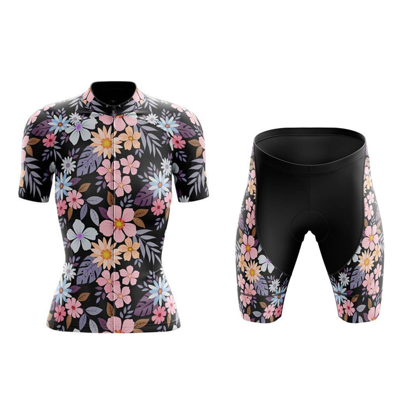 The Womens Floral Cycling Jersey Set is a lightweight polyester ensemble that features pink, white, and orange flowers with green and purple leaves on a black background. The short-sleeved jersey pairs perfectly with the shorts, which include gel seat pads for extra comfort.