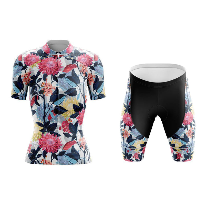 The Womens Floral Red & Blue Cycling Jersey Set includes a lightweight polyester jersey with short sleeves, showcasing vibrant pink, red, and yellow flowers with blue and green leaves. It also features breathable black shorts complemented by matching floral patterns on the leg sections.