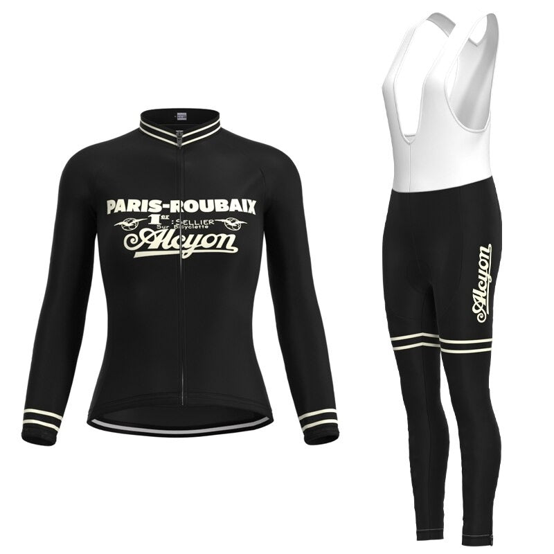 The Womens Paris-Roubaix Retro Cycling Jersey Long Set includes a black cycling kit with a breathable polyester jersey featuring Alcyon text in white and matching black bib tights. Both pieces have classic white detailing on the cuffs and collar.