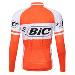 The BIC Orange Long Sleeve Retro Cycling Jersey features an orange and white design, with the bold black BIC logo on the back. It has a fitted style, long sleeves, and convenient lower back pockets. A fleece option is available.