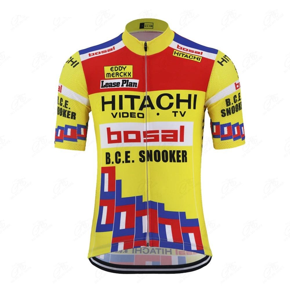 The Hitachi Bosal Eddy Merckx Retro Cycling Jersey is vibrant yellow with red and blue geometric patterns, featuring sponsor logos like Hitachi, Bosal, and B.C.E. Snooker in black text on red and white panels. It has short sleeves and a front zipper for a vintage touch.