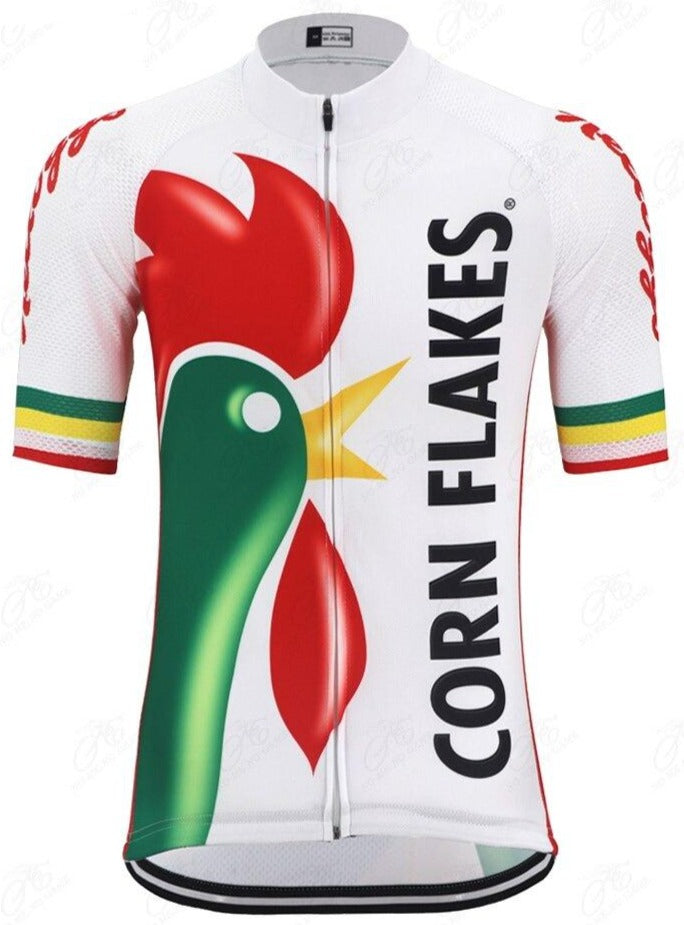 The Kelloggs Corn Flakes Cycling Jersey showcases a bold red and green rooster graphic on a white base, with Kelloggs Corn Flakes in black letters. Colorful stripe accents on the sleeves add flair to this vibrant performance cycling jersey.