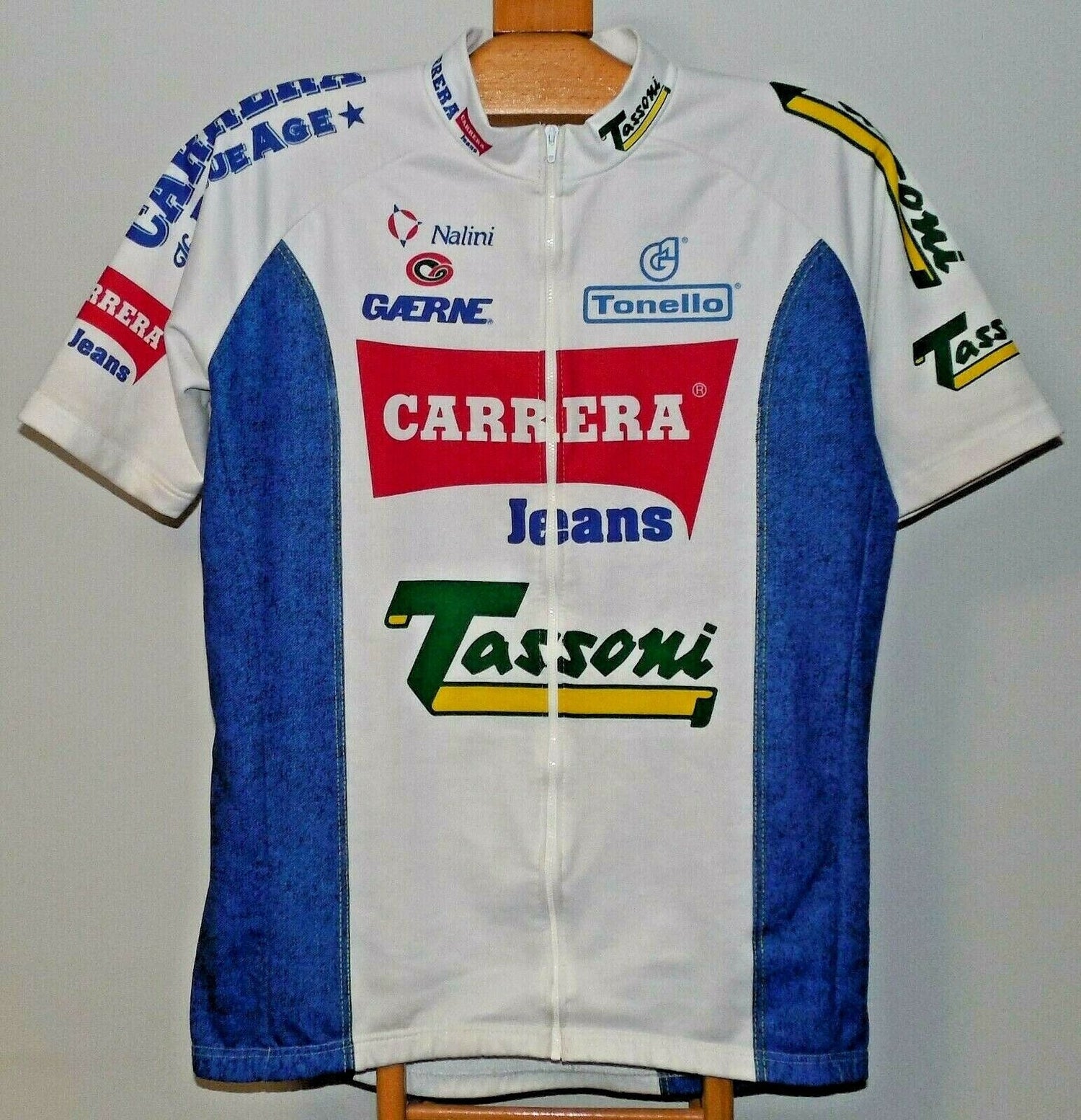 The Carrera Jeans Tassoni 1993 Retro Cycling Jersey in white and blue, inspired by Marco Pantani, features short sleeves, a full zip front, collar, and vibrant logos on the chest, sleeves, and sides.