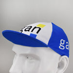The Gan Retro Cycling Cap, displayed on a mannequin head, features a classic retro design with Gan in black letters and a yellow square accent. It has a blue brim and white side panels, offering timeless appeal reminiscent of vintagecycling.shop treasures.