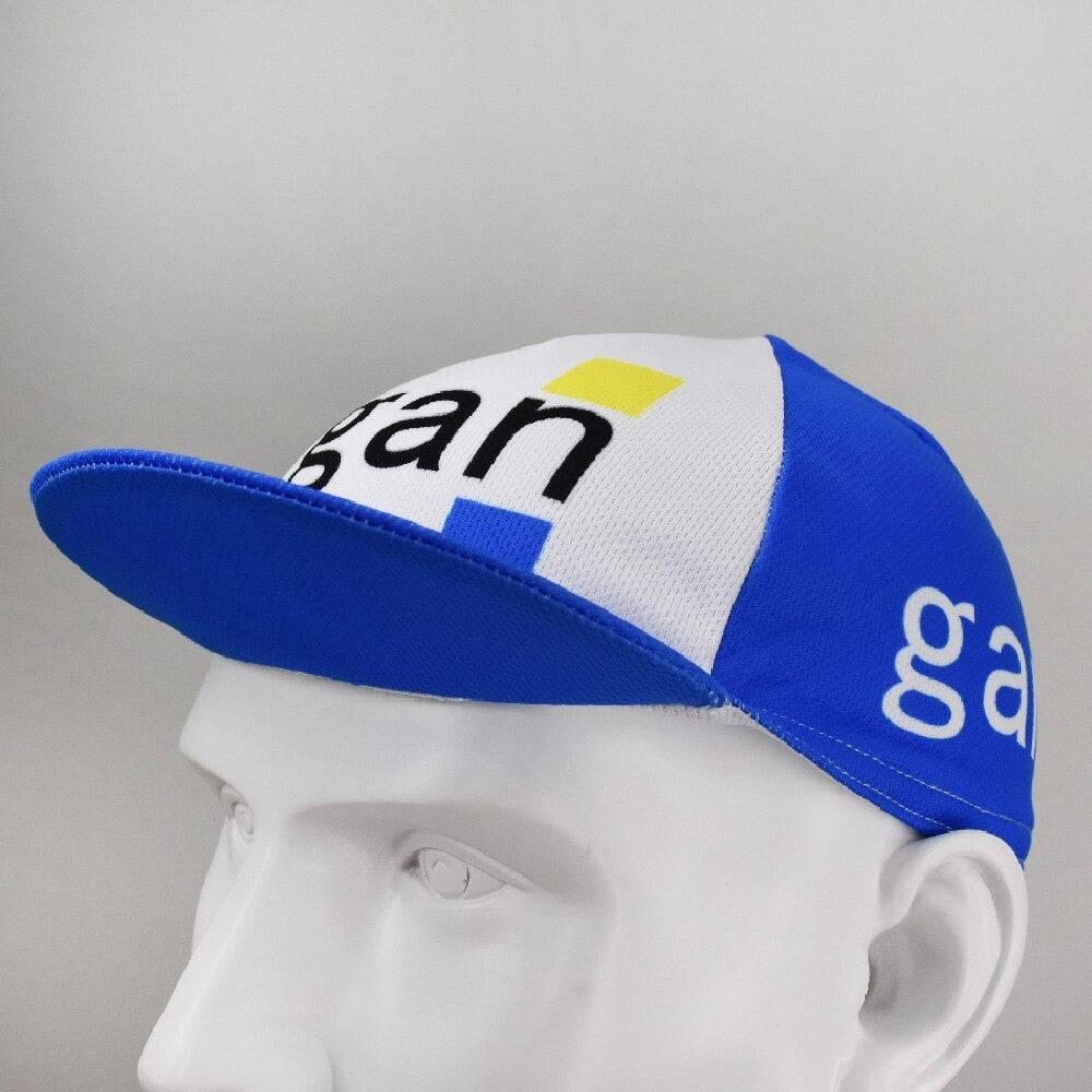 The Gan Retro Cycling Cap, displayed on a mannequin head, features a classic retro design with Gan in black letters and a yellow square accent. It has a blue brim and white side panels, offering timeless appeal reminiscent of vintagecycling.shop treasures.