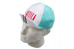 A mannequin head showcases the La Mitica Fausto Coppi Retro Cycling Cap in turquoise and white, featuring La Mitica in red. The brim pays homage to Fausto Coppi with Italian flag colors, celebrating legendary cycling heritage.