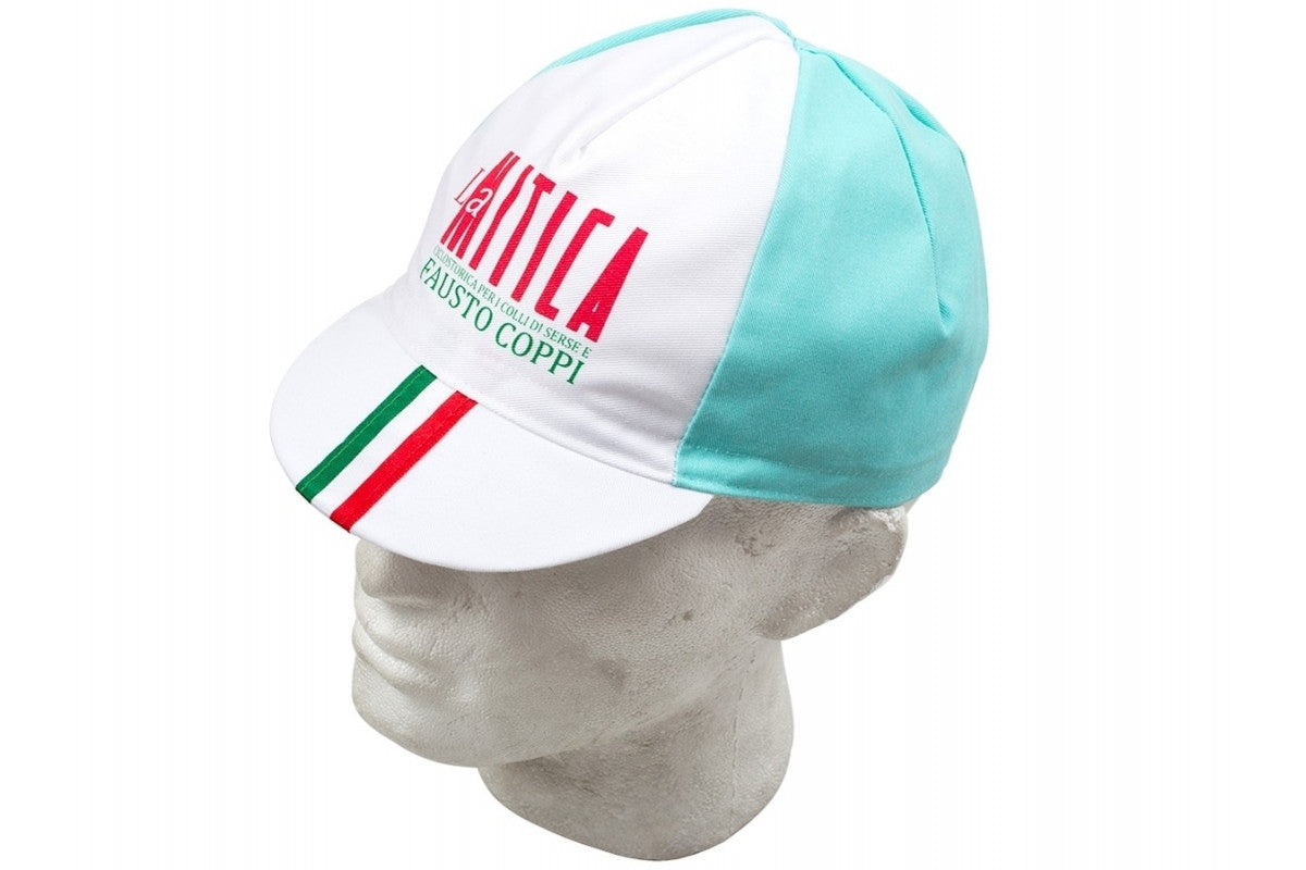 The La Mitica Fausto Coppi Retro Cycling Cap features La Mitica and Fausto Coppi text on the front with Italian flag colors on the brim. Mainly white with light blue panels, its showcased on a white mannequin head.