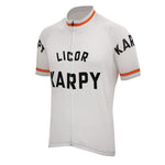 The Karpy Licor 1972 Retro Cycling Jersey is a white short-sleeve jersey with LICOR KARPY prominently displayed on the front and sleeves. It features orange trim at the cuffs and collar, along with a full-length zipper for a vintage 1970s flair.