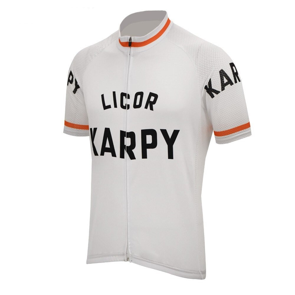 The Karpy Licor 1972 Retro Cycling Jersey is a white short-sleeve jersey with LICOR KARPY prominently displayed on the front and sleeves. It features orange trim at the cuffs and collar, along with a full-length zipper for a vintage 1970s flair.