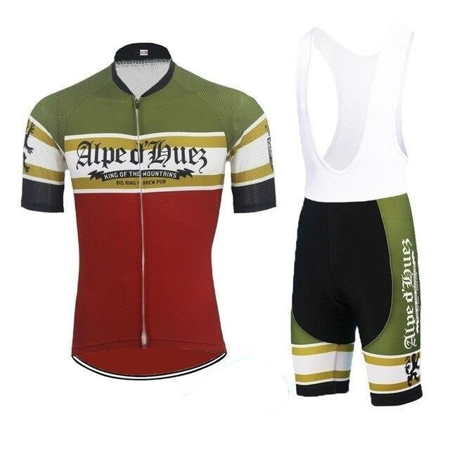 The Alpe DHuez Retro Cycling Jersey Set includes a short-sleeved jersey in olive green and red with white and yellow stripes, paired with black cycling shorts featuring matching stripe accents, combining style and performance.