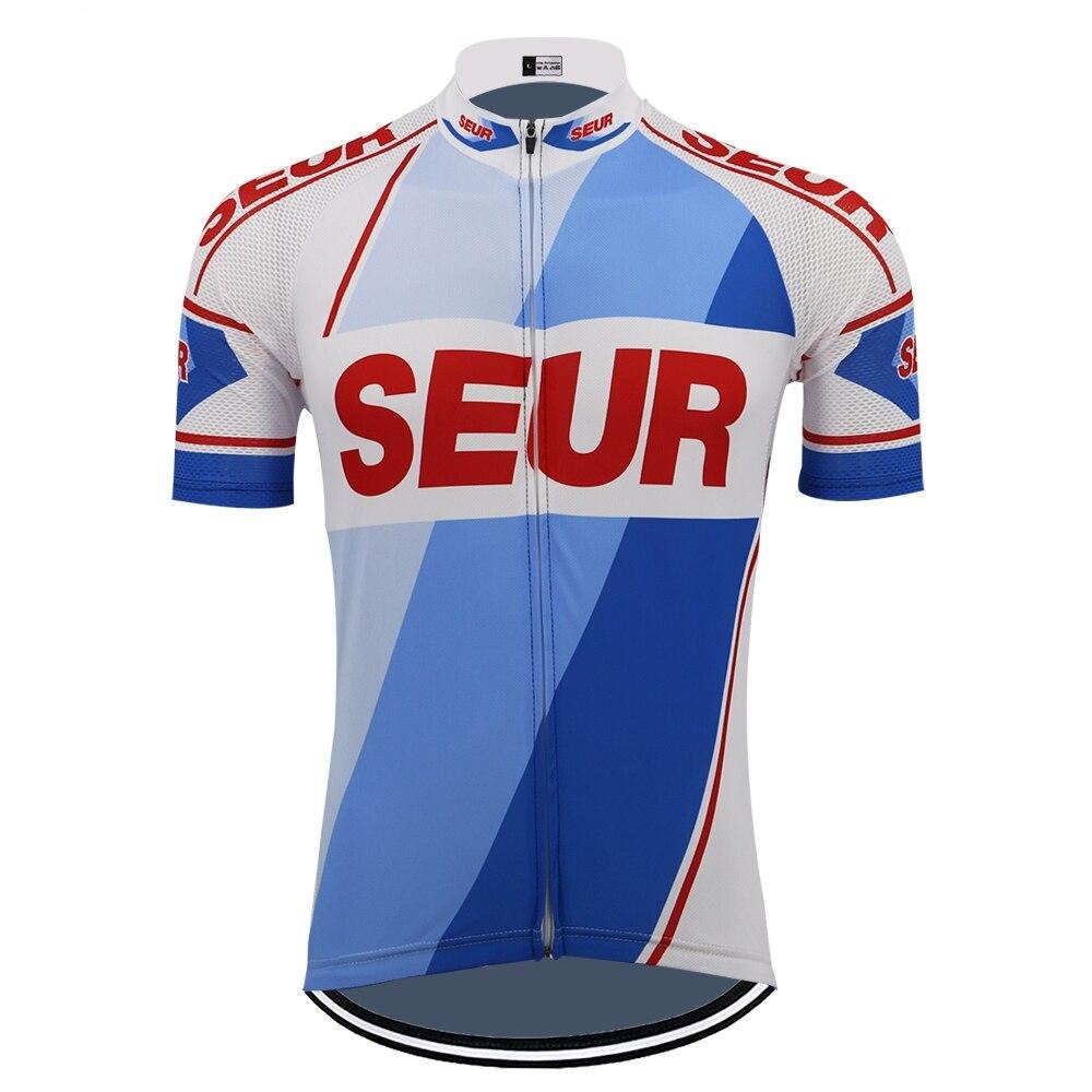 The SEUR Retro Cycling Jersey in white and blue is made from lightweight polyester for comfort, featuring SEUR in red on the chest and geometric sleeve patterns. A front zipper enhances its performance and style.