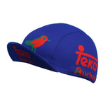 The Teka Auchan Cycling Cap features a blue base with red and green designs, including a stylized bird and text logos. Its made from breathable mesh fabric, ensuring moisture absorption for optimal comfort during your ride.