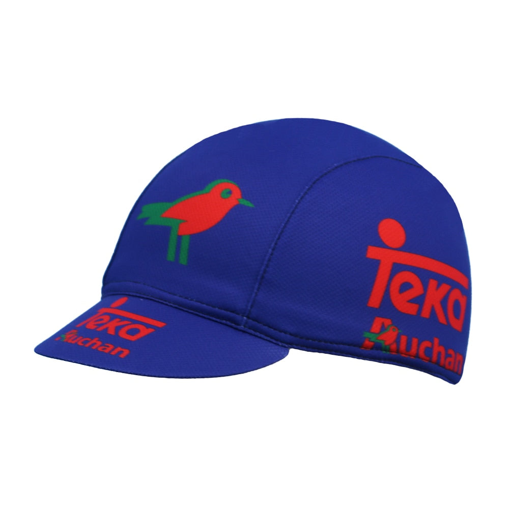 The Teka Auchan Cycling Cap, made from breathable mesh fabric, features a blue design with a red and green bird graphic on top, along with bold Teka and Auchan logos on the front and sides. Its stylish and moisture absorbent for a comfortable ride.