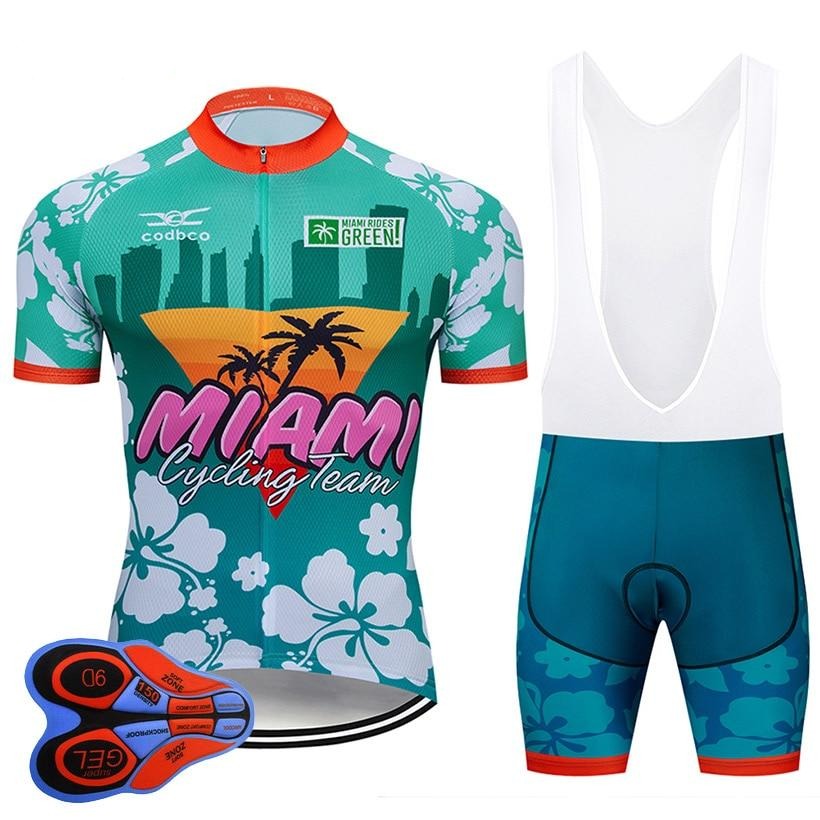 Join the Miami Cycling Team with a retro cycling jersey set featuring a tropical theme. The teal and red jersey and bib shorts are adorned with palm trees and florals, offering padded seat inserts for comfort while riding in style.