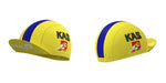 Yellow caps from the Womens KAS Canal Retro Cycling Jersey Set feature blue stripes and a KAS print on the sides, reminiscent of vintage cycling gear. The Canal 10 logo adorns the brim and side, with hats displayed from two angles against a white background.