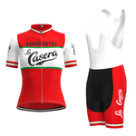 Introducing the Womens La Casera-Bahamontes Retro Cycling Jersey Set in red and white, featuring La Casera and BAHAMONTES text with a green chest stripe, paired with matching bib shorts.