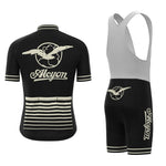 The Paris-Roubaix Retro Cycling Jersey Set features a black and white short-sleeve jersey with an Alcyon logo and flying bird emblem. It includes striped detailing, while the matching bib shorts have breathable gel seat pad technology and side branding, complemented by a solid white upper section.