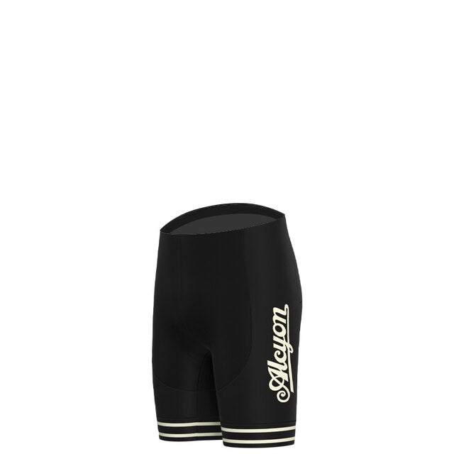 The Paris-Roubaix Retro Cycling Jersey Set features black cycling shorts with a cursive logo on the side and two white stripes near the leg openings, tailored for performance cycling. Presented against a white backdrop, it combines style and function for avid cyclists.